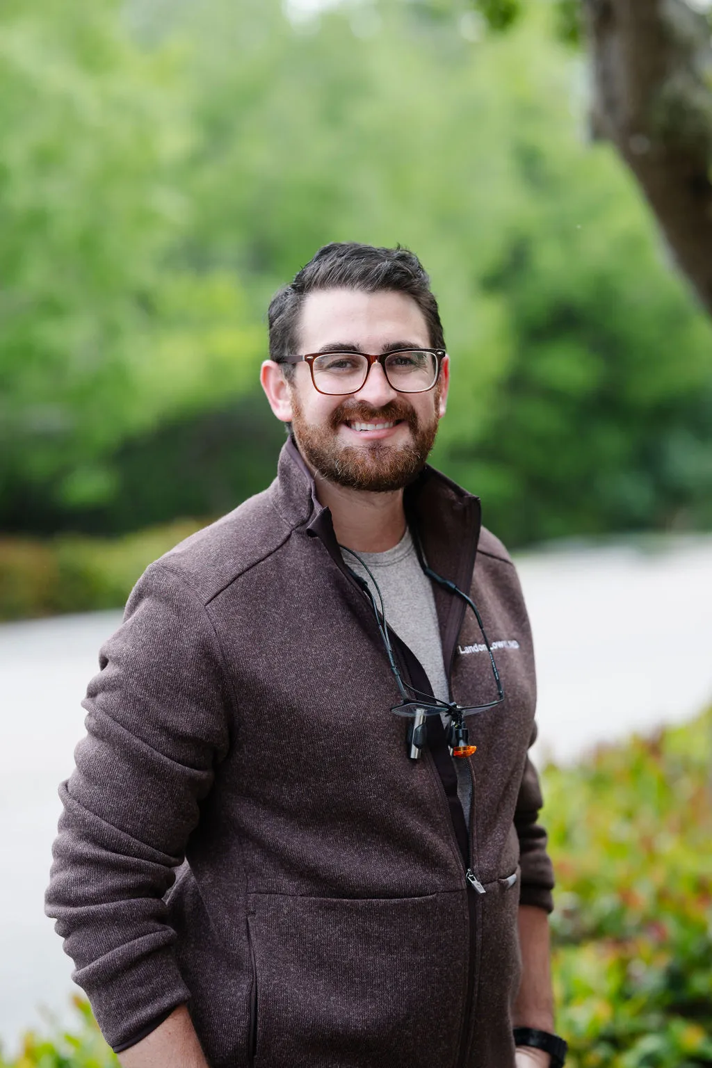 Dr. Lowell – Your Friendly Naples Dentist - suncoast dental center reviews Portrait of Dr. Lowell standing outdoors with a warm smile, wearing casual professional attire, representing Suncoast Dental Center’s welcoming approach. - suncoast dental center reviews